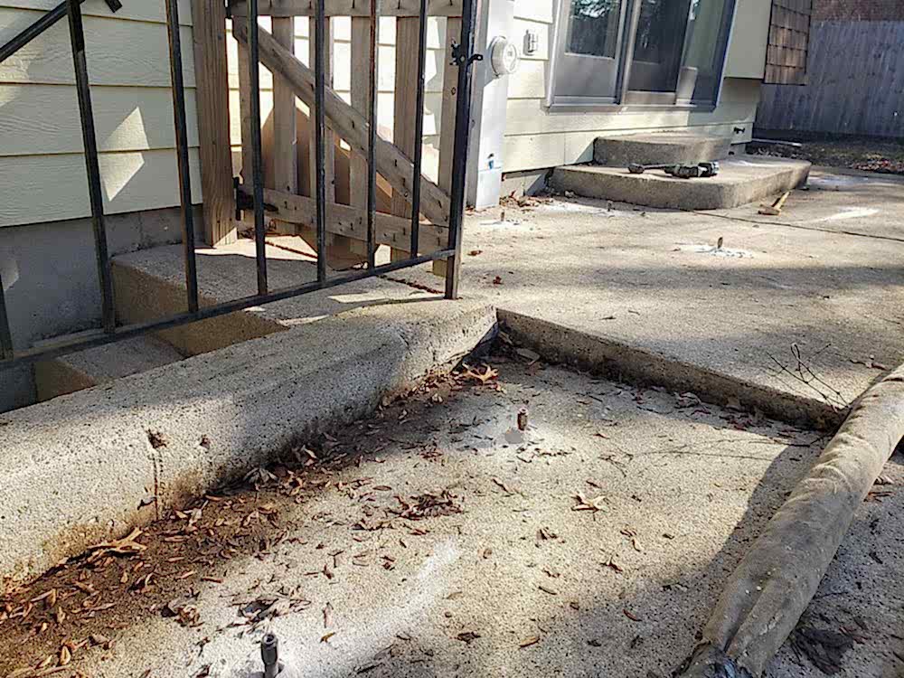 patio leveling, lifting, and repair services being done