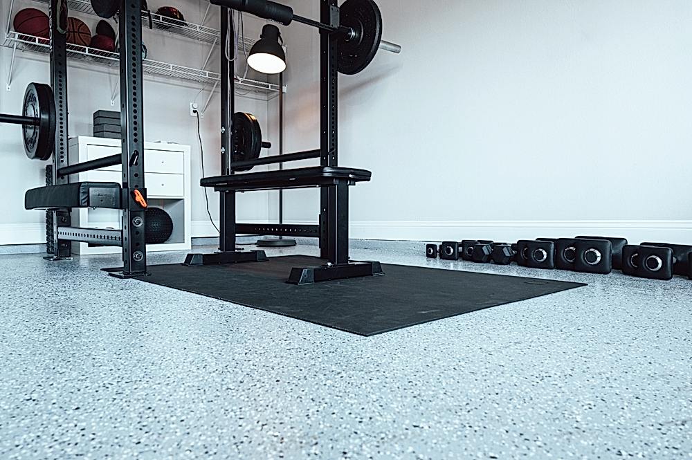finished concrete coating in basement with gym equipment